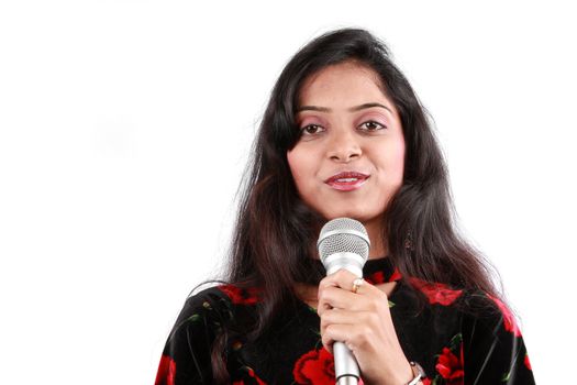 A portrait of a beautiful female host of a talk show in India, on white studio background.