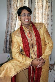 An Indian groom wearing the traditional sherwani attire.