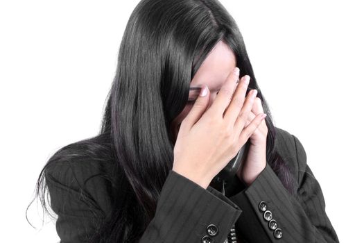 A depressed Indian businesswoman crying while on a phone call, due to recession times.