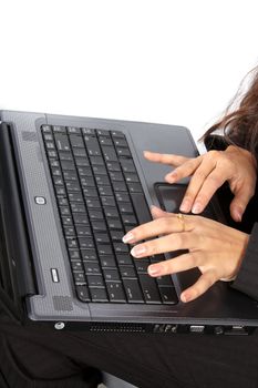 The hands of an businesswoman typing on a laptop keyboard.