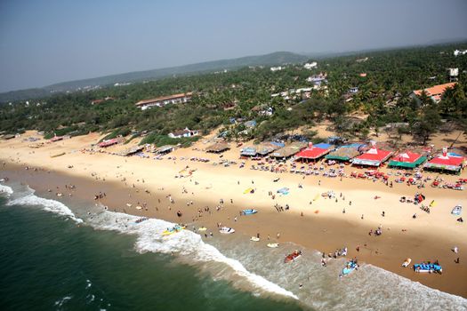 An aerial view of a crowded beach in Goa, India.