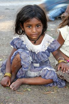 A portrait of a cute poor girl from India.