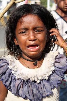 A poor Indian girl crying for food.