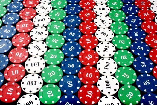 A background of colorful casino chips in a diagonal pattern.