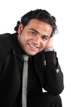 A portrait of a handsome young Indian businessman, on white studio background.