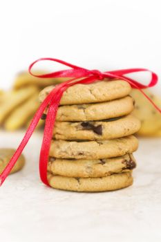 Cookies decorated with red ribbons with focus on stack of cookies.