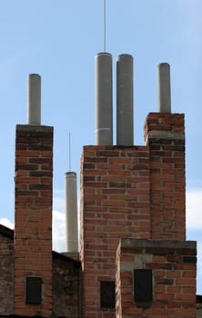 Many of brick chimneys on the top of the house