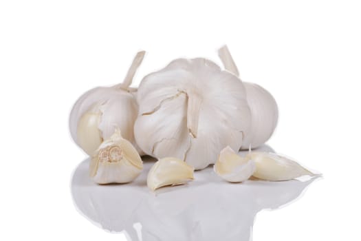 Bunch of whole garlic isolated on white with soft reflection