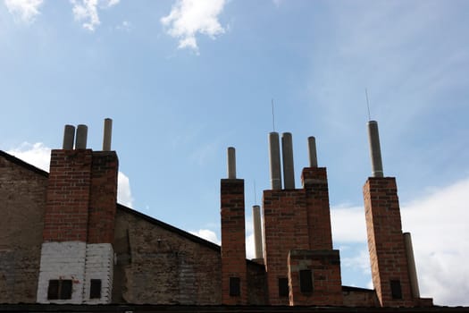 Many of brick chimneys on the top of the house