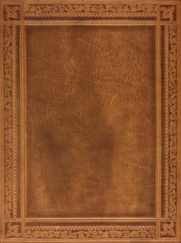 brown leather book or journal cover with a decorative floral ornament