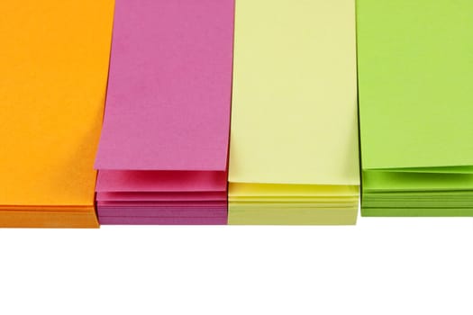 small colorful (orange, pink, yellow, green) post-it notes isolated on white