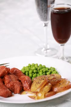 Delicious barbecued pork meal on table setting