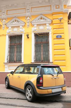 yellow car near old-time building number 13