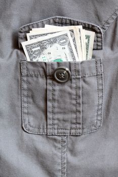 One dollar bank notes inside open khaki jacket pocket