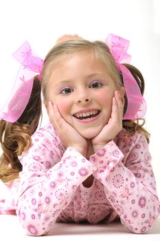 young pretty blond girl laying on the floor and smiling