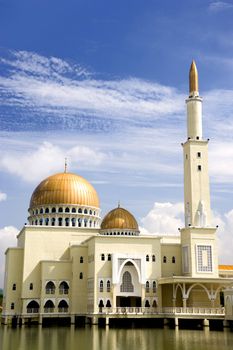 Mosque with gold coloured domes and minaret in Malaysia.