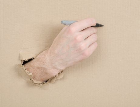 Hand with marker written on cardboard sheet