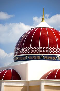 A modern red domed mosque in Malaysia.