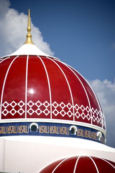 A modern red domed mosque in Malaysia.