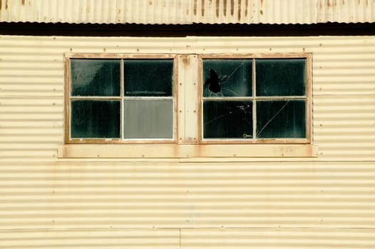 Windows on an old currugated metal building.