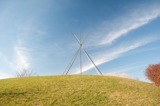 Frame for an American Indian tent in the nature under blue sky
