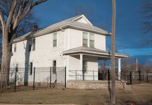 Old style American home under a beautiful blue sky