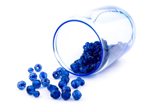 Picture of blue beads in glass dish on white background