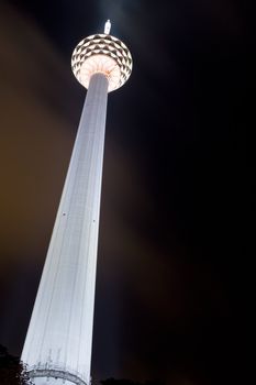 Night image of the Kuala Lumpur Tower located in Malaysia. This is a communications tower with a viewing gallery and restaurant right at the top. An important landmark in Kuala Lumpur.