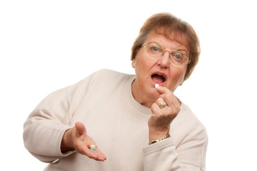 Attractive Senior Woman Taking Pills Isolated on a White Background.