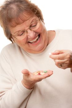 Attractive Senior Woman and Pills Isolated on a White Background.