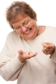 Attractive Senior Woman and Pills Isolated on a White Background.