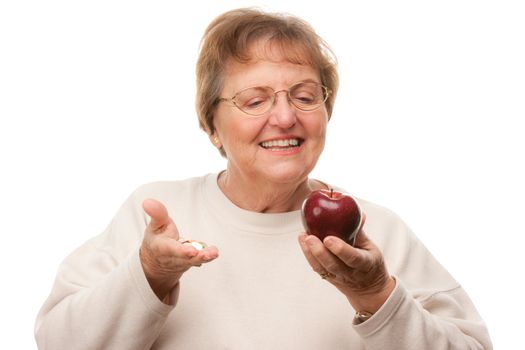 Happy Attractive Senior Woman Holding Apple and Vitamins Isolated on a White Background.