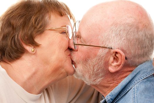 Affectionate Senior Couple Kissing Isolated on a White Background.
