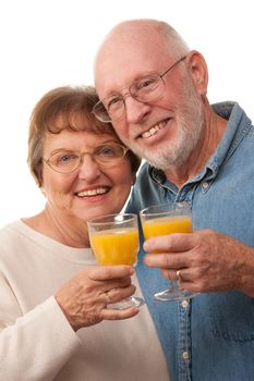 Happy Senior Couple with Glasses of Orange Juice Isolated on a White Background.