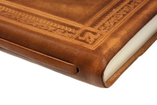 corner of book or diary in leather cover with floral ornaments, isolated on white