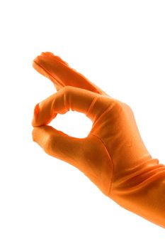 hand in orange glove is making the ok sign over white