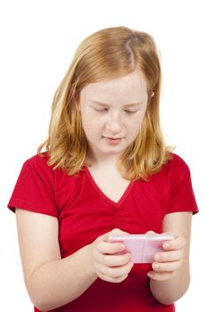 little girl is text messaging on a pink phone isolated on white