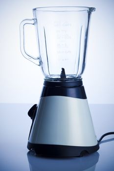 Empty blender on the kitchen table over white background