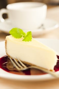 Cheese cake with coffee cup on the table