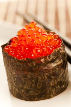 Salmon roe  seaweed sushi roll on the bamboo table