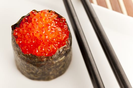 Salmon roe  seaweed sushi roll on the bamboo table