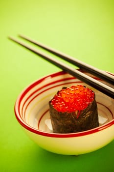 Salmon roe  seaweed sushi roll on the green table