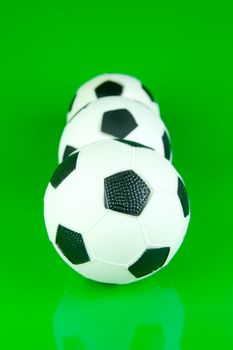 A soccor ball isolated against a green background