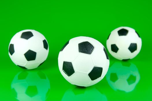 A soccor ball isolated against a green background