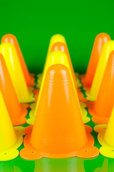 Witches hats isolated against a green background