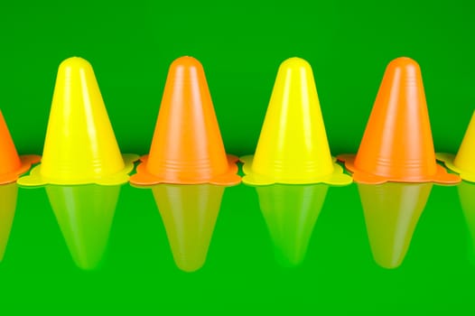 Witches hats isolated against a green background