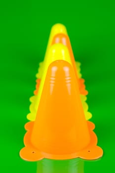 Witches hats isolated against a green background