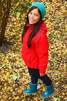 Young beautiful woman walking in colorful fall forest