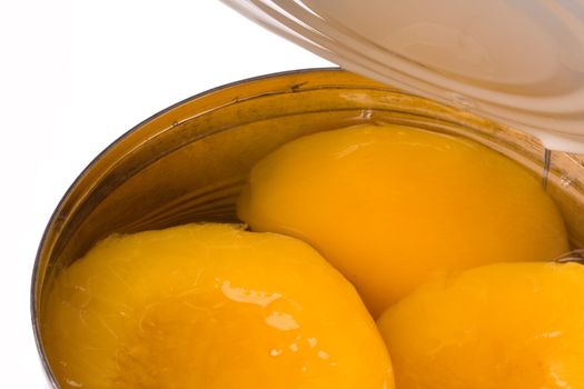 Isolated image of canned peaches in syrup.