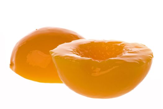 Isolated image of canned peaches in syrup.